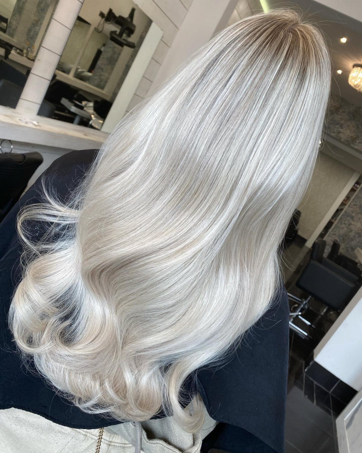 Long silvery sandy blonde hair with smooth layers and softly curled ends
