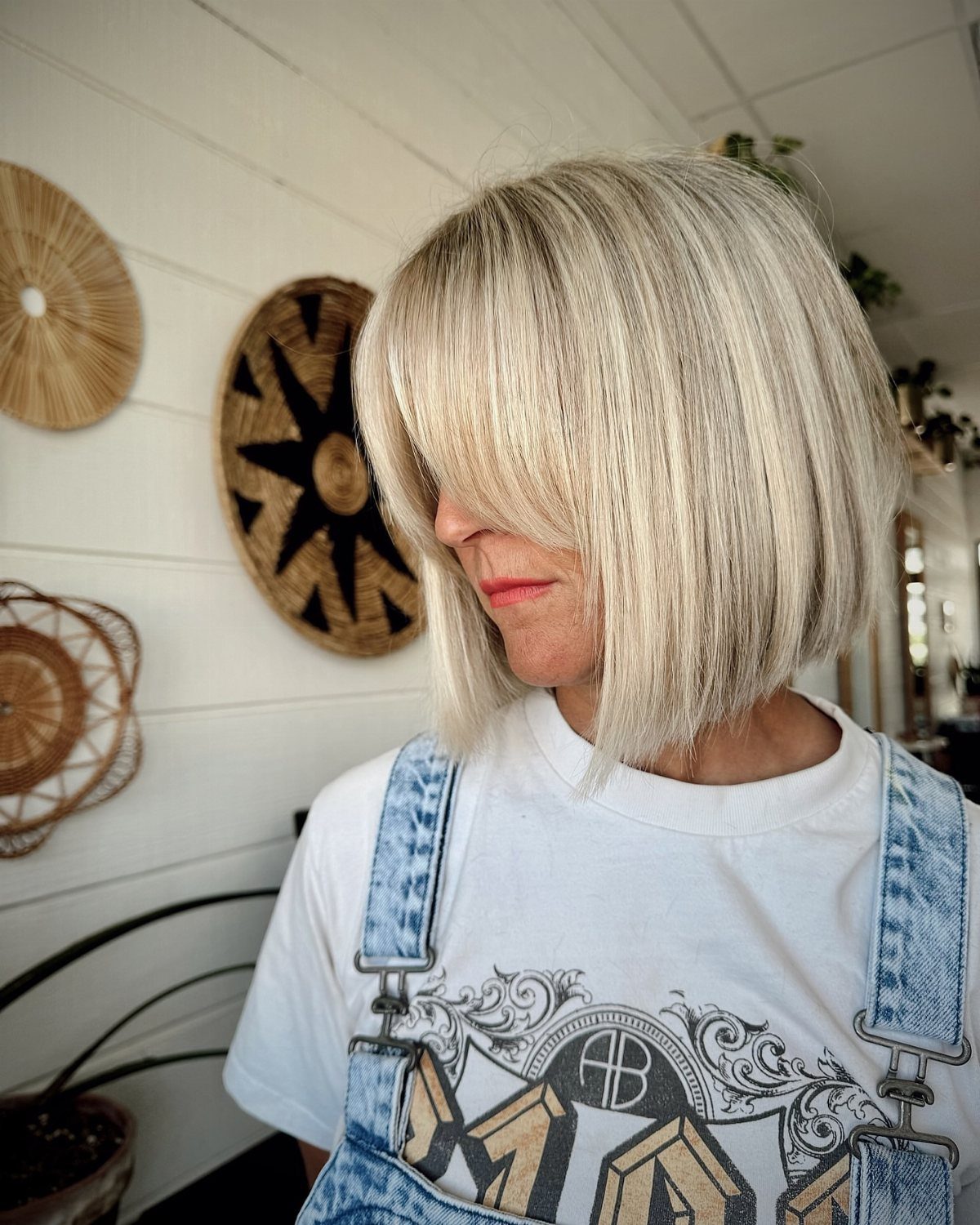Blonde woman with a blunt chin-length bob and full bangs