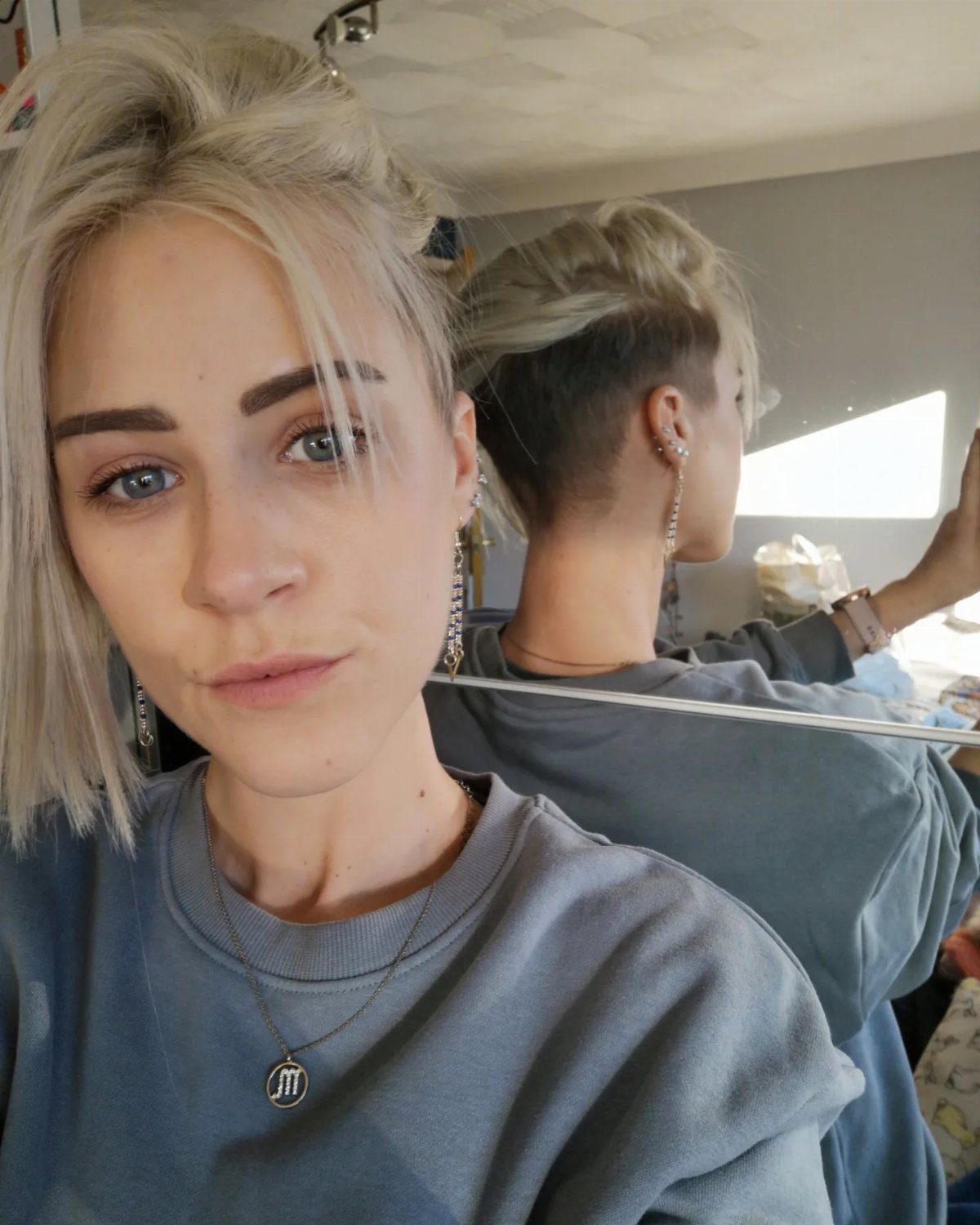 Woman showing a short, pale blonde asymmetrical bob with longer front pieces
