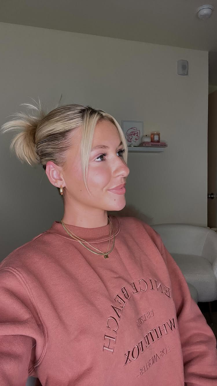 Blonde woman with short-looking pulled-back hair and long face-framing strands