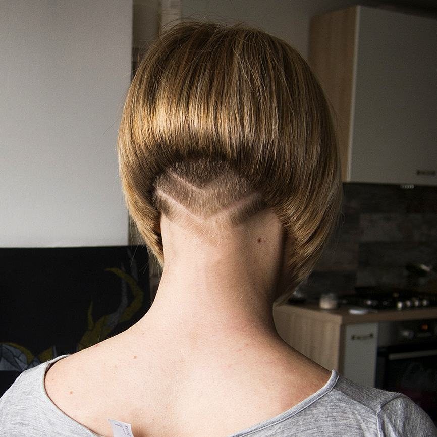 Short blonde bob tapered closely at the nape, viewed from behind