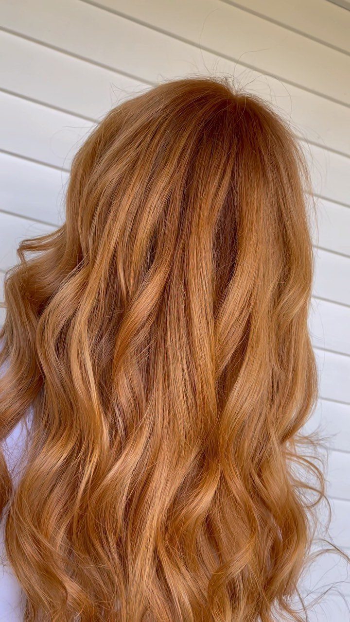 Long wavy copper strawberry blonde hair with warm golden and reddish tones