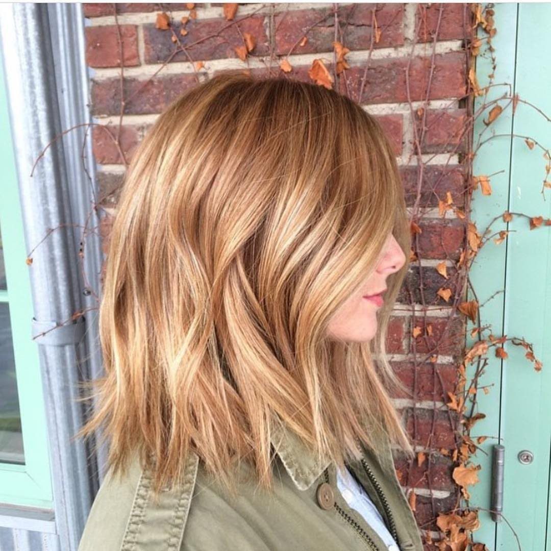 Shoulder-length strawberry blonde hair with warm highlights in loose waves