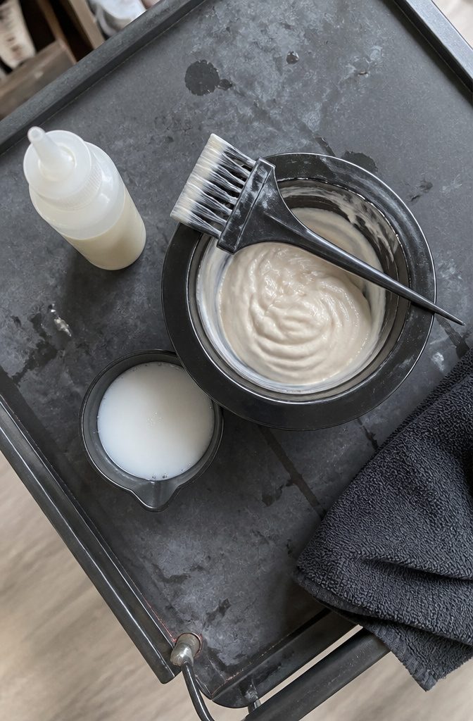 Creamy toner mixed in a bowl with an applicator brush
