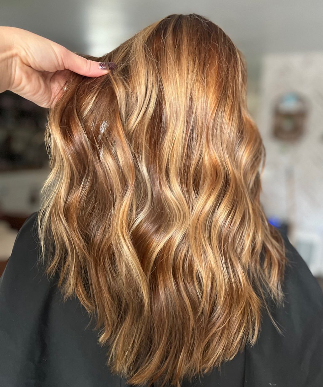 Wavy brown hair with bright caramel and golden blonde highlights