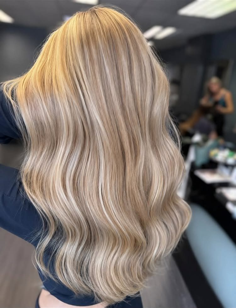 Long wavy warm beige blonde hair with subtle golden tones