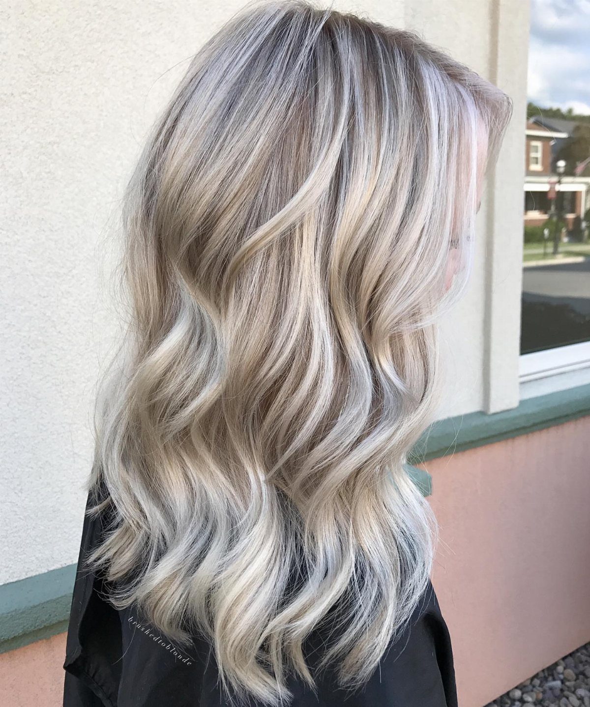 Long icy white-blonde waves with soft silver lowlights throughout
