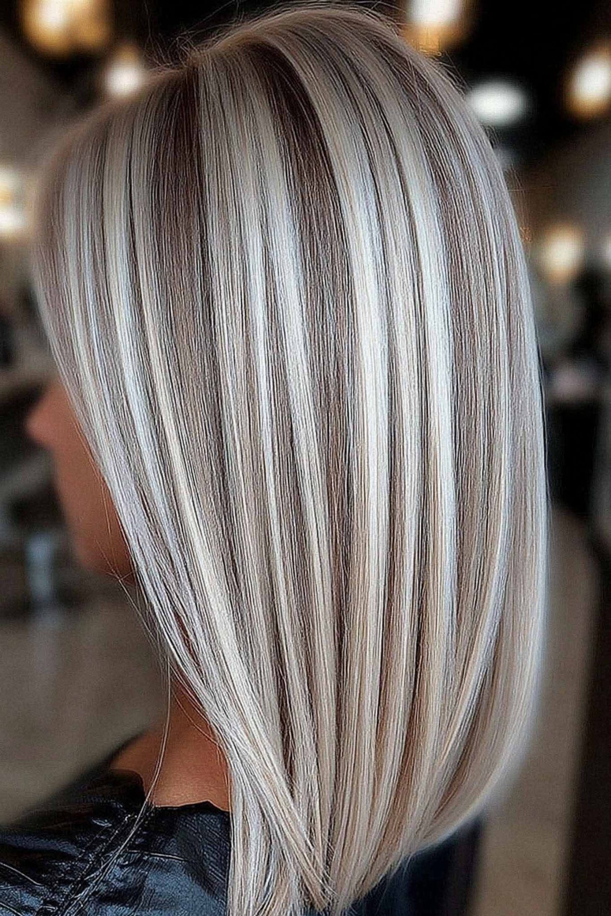 Straight silver-white bob with fine gray lowlights and a dark center part