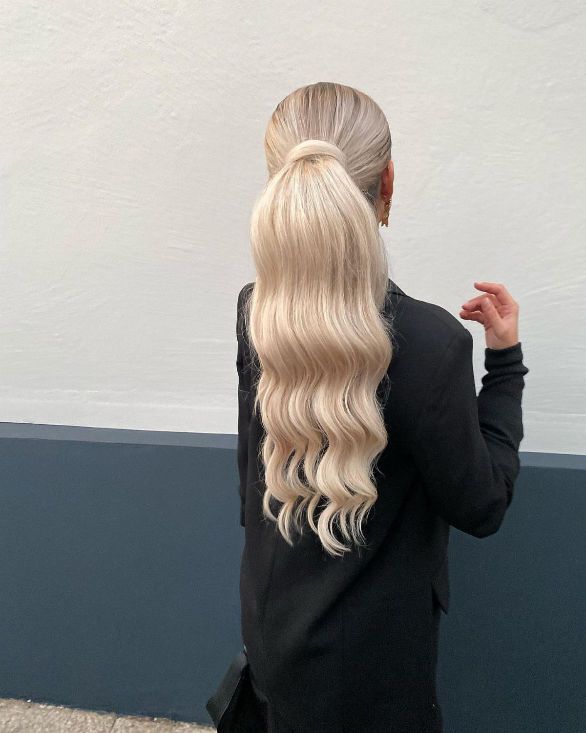 High ponytail of long white-blonde hair with softly waved ends
